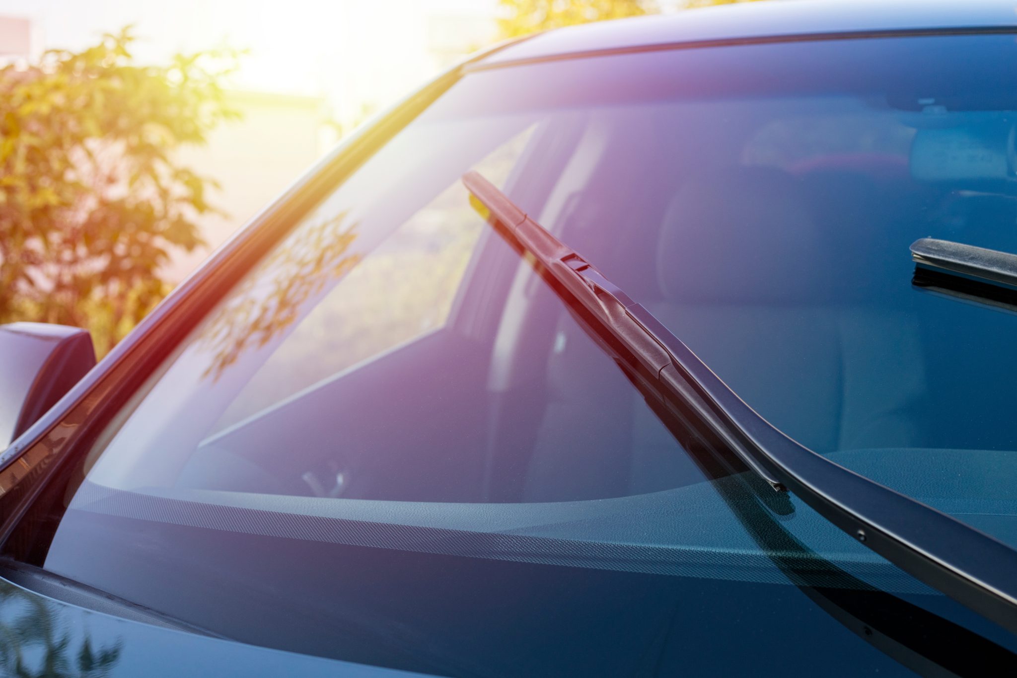 Chevrolet Silverado windshield replacement in Phoenix, Arizona - windshield wipers clearing the glass in evening light