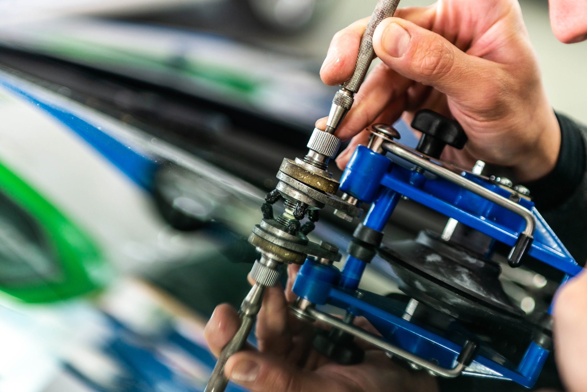 Dodge windshield replacement in Phoenix, Arizona - technician using specialized windshield repair equipment