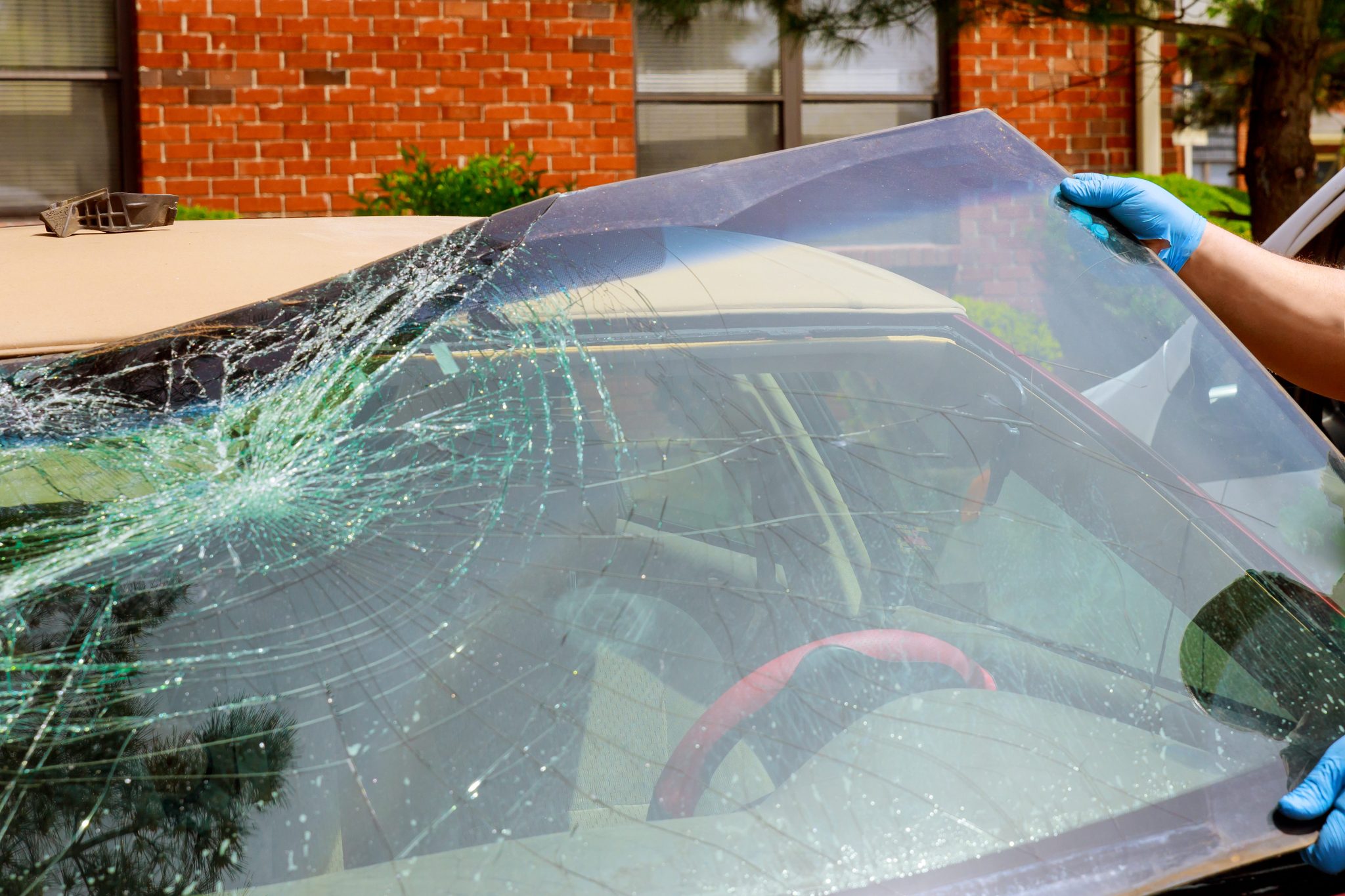 Kia Forte windshield replacement in Phoenix, Arizona - damaged windshield being removed for replacement